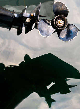 Bright steel propellor blades gleaming in the summer light just after sunset,over the calm waters of Kotor Bay.の写真素材