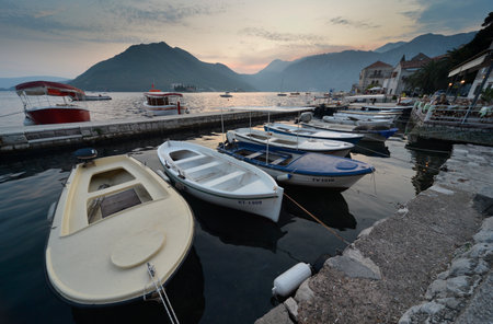 Perast,Montenegro-September 7th 2019: On a summer's evening as dusk fades,boats rest peacefully on the calm waters of Kotor Bay.のeditorial素材