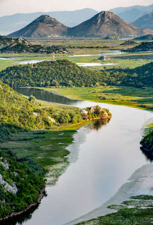 View from Pavlova Strana viewpoint of the river winding around the hills and mountains towards the lake,and the Albanian mountains in the distance.の写真素材