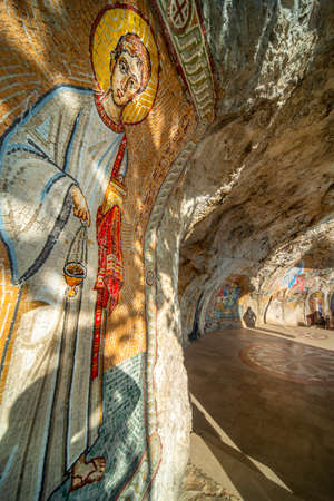 The caves at the upper monastery adorned with Christian Serbian orthodox imagery of saints and religious scenes at Montenegro's most popular pilgrimage site.の写真素材
