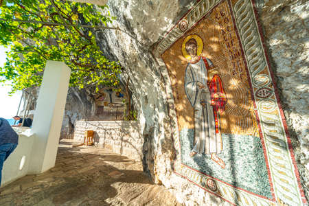 Christian orthodox artwork,colorfully covering the interior cave walls at the popular pilgrim and tourist site,the monastery is built high up,into the mountain side of Ostroska Greda.のeditorial素材