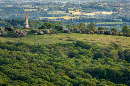 The Monument on the Eastnor Estate,viewed in the distance from the Malvern Hills, standing in summer sunlight soon after dawn.A prominent landmark in Heredfordshire,part of Eastnor Castle grounds.のeditorial素材