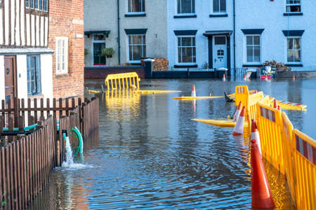 Bewdley,Worcestershire,England,UK- February 22 2022: Flood wate from the nearby river Severn has to be pumped out of homes,into already flooded roads that have been cut off to traffic.のeditorial素材