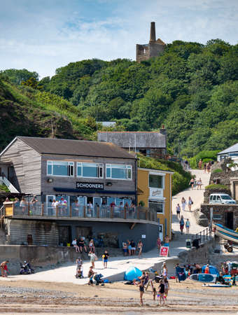 St.Agnes,Cornwall,England,UK-July 22: The relic of a disused tin mine overlooks the now family...