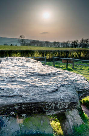 Large stones of the inner burial chamber,5000 years old.Close to Welsh border.Overlooking the Golden Valley, Herefordshire and the Wye Valley,linked to King Arthur.End of sunny spring day.の写真素材