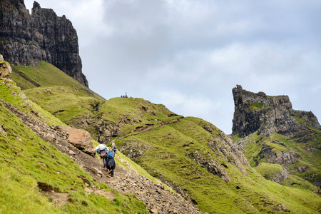 Quiraing,Isle of Skye,Scotland,UK-July 25 2022: Hikers walk along the mountain paths of the Quraing mountain range,,on a summer day,taking in the dramatic,landscape views.のeditorial素材