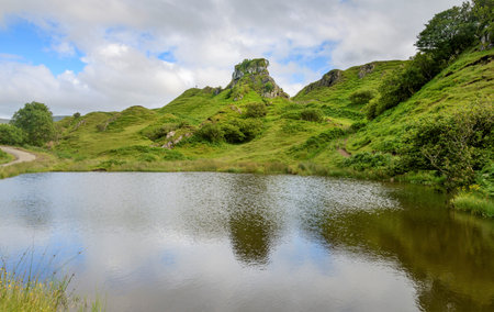 Castle like rocky basalt prominence,with beautiful views of surrounding, cone shaped hills and mounds,a cute,surreal,fantasy like,grass covered landscape.A popular tourist site near Uig on Skye.の写真素材