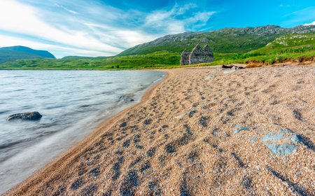 Next to a sandy beach,a ruined historical Georgian mansion, on the east shores of Loch Assynt,built 1726 for Kenneth MacKenzie of nearby Ardvrek Castle,first classical house in northwest highlands.の写真素材