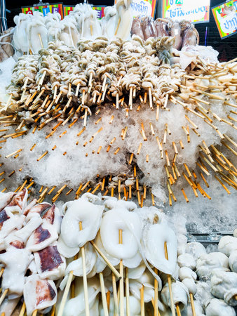 Bangkok food market, marine street food ,featuring a large stack of fresh, chilled seafood,ready to barbecue and cook as snacks for passing customers.の写真素材