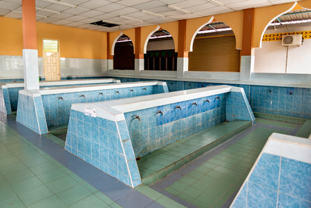 A Wadhu facility, a dedicated area for ritual washing before prayer. an ablution space for...
