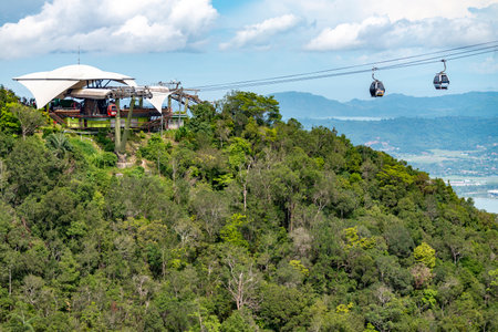 Running high over the forested peaks of Mat Cincang,the second highest mountain in Langkawi,a major tourist destination, with awesome views across the island, and location of the Langkawi Sky Bridge.の写真素材