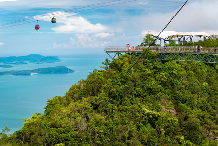 Langkawi cable cars run across spetacular scenery on the Island,seen from the steel cable stayed bridge,winding high over the forested peaks of Mat Cincang,second highest mountain in Langkawi.の写真素材