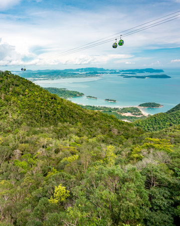 Cable car gondolas travel to and fro the Middle and Upper stations,against a beautiful backdrop of Lankawis countryside,coastline and tree covered mountain peaks,a major tourist destination.の写真素材