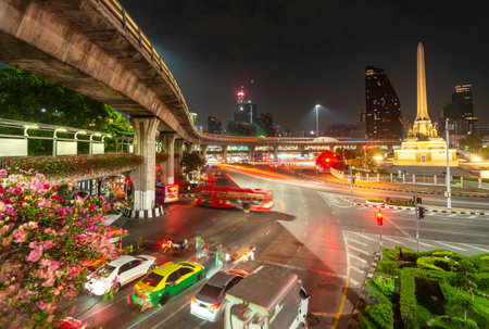 Traffic waiting at a busy junction and many vehicles rush under huge concrete columns,architecture...