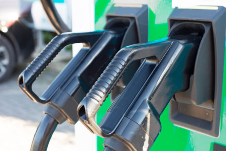 EV charge point,standing in a row, next to car parking spaces at a public electric vehicle charging...
