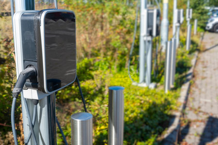 EV charge point,standing in a row, next to car parking spaces at a public electric vehicle charging...