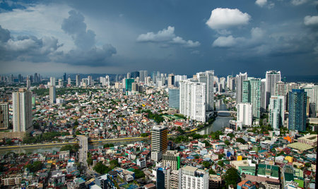 The capital city brightly lit,near to sunset,contrasting with a dark sky as rain approaches.lit...
