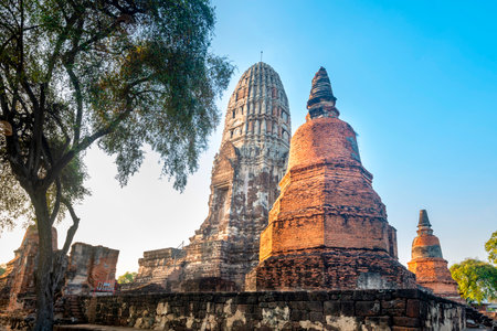 The distinctive and famous pagodas of Wat Phra Si Sanphet,at sunset,in the beautiful grounds of the iconic ancient Royal Palace,of the former capital of Siam.の写真素材