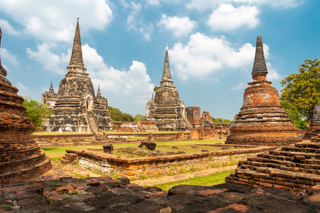 The distinctive and famous pagodas of Wat Phra Si Sanphet,at sunset,in the beautiful grounds of the iconic ancient Royal Palace,of the former capital of Siam.の写真素材