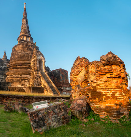 Part of the extensive temple grounds and important historic site,with many ancient Buddhist pagodas,with surrounding brickwork,bathed in the warm light of the setting sun.の写真素材
