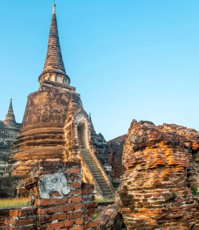 Part of the extensive temple grounds and important historic site,with many ancient Buddhist pagodas,with surrounding brickwork,bathed in the warm light of the setting sun.の写真素材