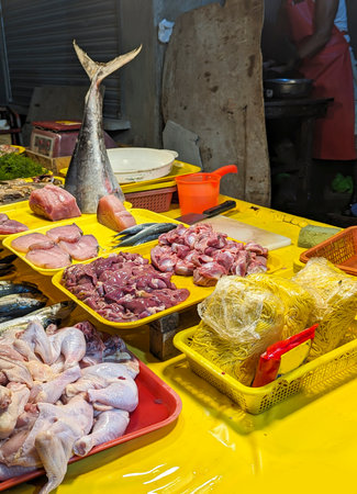 Assorted food items,like tuna,garlic,ginger,courgettes etc.,on display at a small local seaside market,used by the local people of a small poor residential area next the sea.の写真素材
