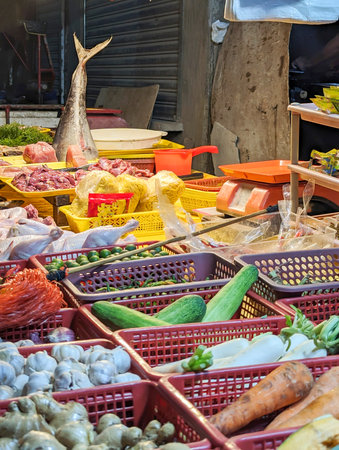 Assorted food items,like tuna,garlic,ginger,courgettes etc.,on display at a small local seaside market,used by the local people of a small poor residential area next the sea.の写真素材
