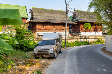 Thailand-January 26 2025: Local dwellings, along a typical small main road, part of a small network, running through lush vegetation, waterways, natural habitats and farmland.の写真素材