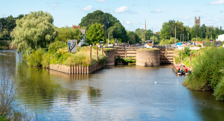 Ponorama of the unique double lockca at the end of the Worcester and Birmingham canal, on a beautiful late mid-summer afternoon,near to historic Worcester Cathedral.の写真素材