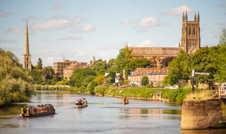 On a beautiful late mid-summer afternoon,canal boats drift along the serene waters,with historic...
