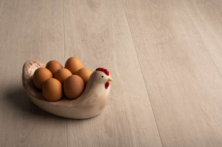 Eggs, in a  dish on a light wood background with copy spaceの写真素材