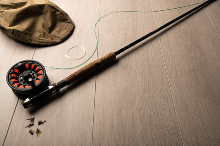 Fly fishing tackle on a light wood background with copy spaceの写真素材
