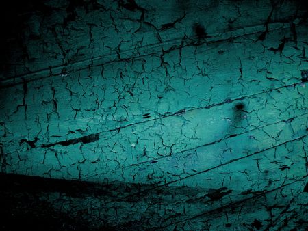 Dark shadow around turquiose blue cracked wooden background showing the hull of a old boat, created using several photographsの写真素材