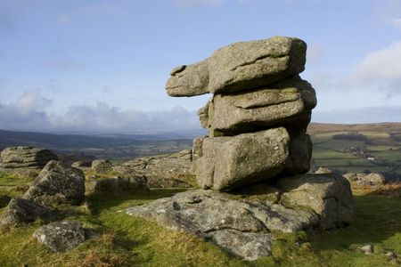 Pile of rocks formation in shape of number 1 one, with view over moors Dartmoor, Devon, England UKの写真素材