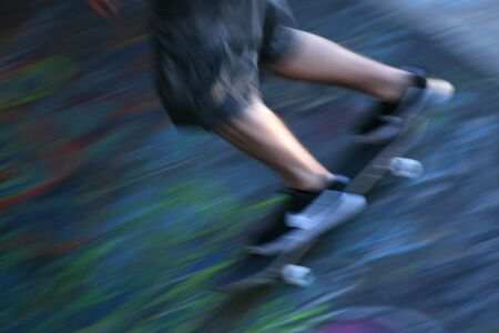 Blurred motion of skateboarder speeding down the slope, Southbank, London, England, UKの写真素材