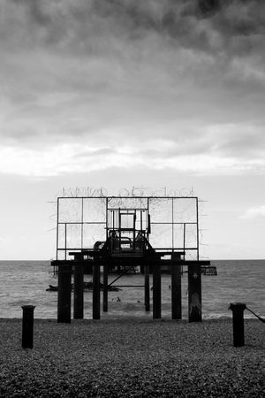 Black and white image of the remains of Brighton West Pier after fire, England, UK