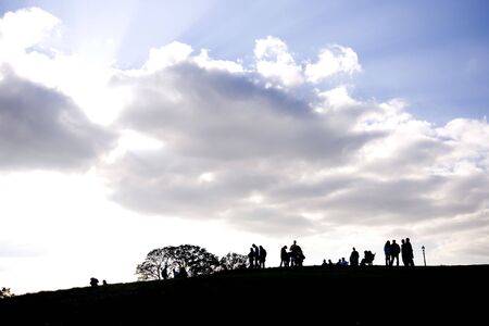 Silhouette of people on top of Primrose Hill, North London, England, UKの写真素材