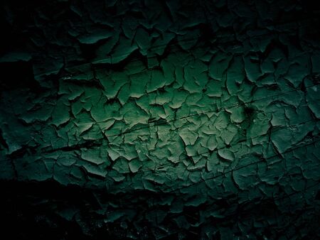 Dark shadow around green cracked wooden backgroundの写真素材