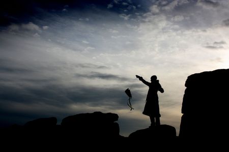 Girl flying kite on rocks, Dartmoor, Englandの写真素材