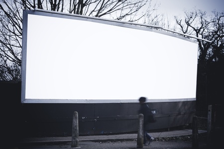Man walking past blank billboardの写真素材