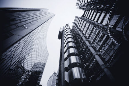 LONDON - SEPTEMBER 21  The Lloyds building reflected in the Willis Building pictured on September 21, 2013, during the annual Open House event in London, UK  Design by Richard Rogers and opened by Queen Elizabeth II in 1986 のeditorial素材