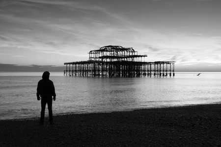 Remains of Brighton Pier left standing in sea at sunset Brighton West Pier England UKの写真素材