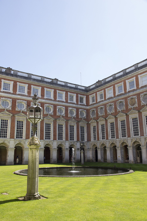 LONDON, UK - May 11, 2018. Courtyard at Hampton Court Palace which was originally built for Cardinal Thomas Wolsey 1515, later became King Henry VIII residence. London, Uk - May 11, 2018のeditorial素材