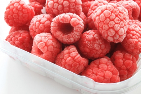 frozen raspberries in plastic punnet