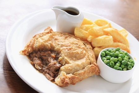 traditional beef steak pie with chips and peas
