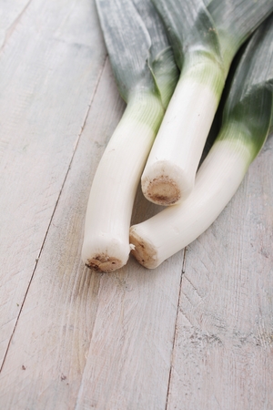 fresh leeks on wooden tableの写真素材