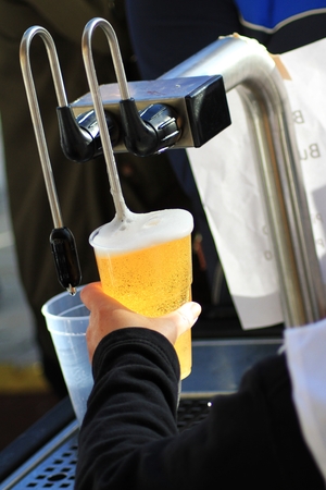 serving beer tap pumpの写真素材