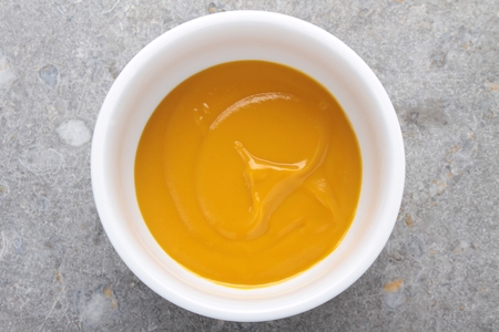mango fruit puree in white bowlの写真素材