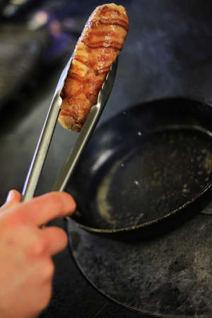 chef cooking and preparing plated mealの写真素材