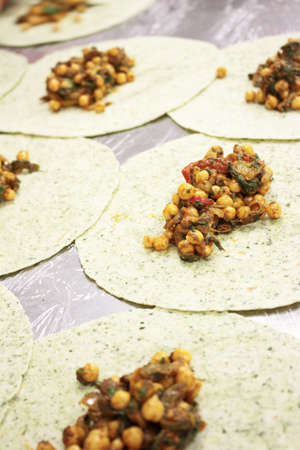 chef preparing indian chick pea wrapの写真素材
